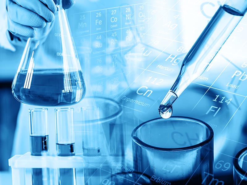 hand of scientist holding flask with lab glassware and test tube